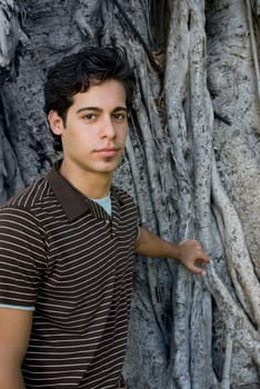 Portrait of a young man in front of a tree