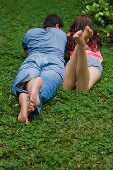 Rear view of a young couple lying in a park