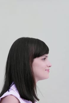 Side profile of a young woman smirking