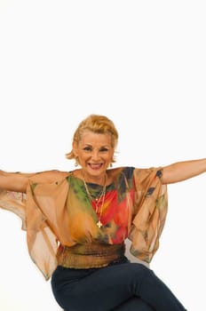 Portrait of a senior woman sitting with her arms outstretched and smiling