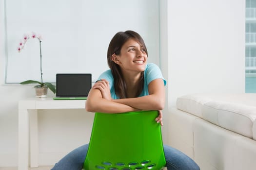 Teenage girl sitting on a chair and smiling