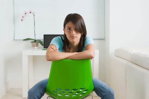 Portrait of a teenage girl sitting on a chair