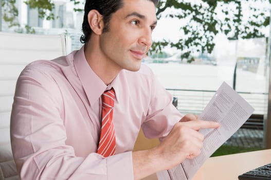 Businessman holding a form in an office