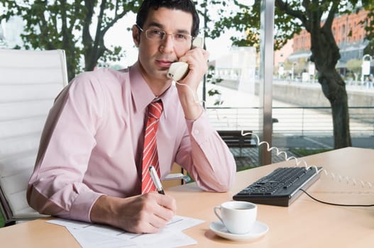 Businessman talking on the telephone in an office