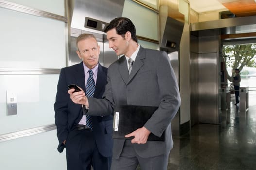 Businessmen walking in a corridor