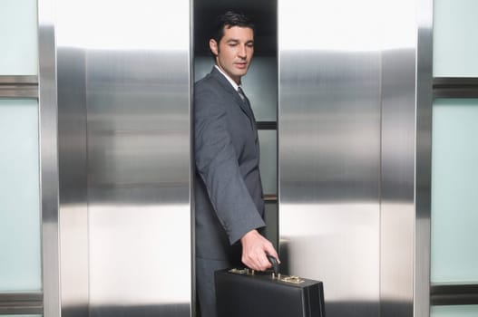 Businessman standing in an elevator