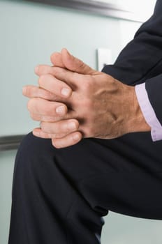Businessman with hands clasped