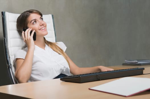 Businesswoman talking on a mobile phone in an office