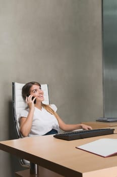 Businesswoman talking on a mobile phone in an office