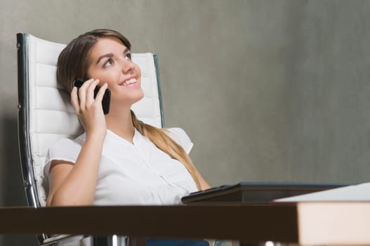 Businesswoman talking on a mobile phone in an office