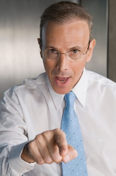 Portrait of a businessman pointing forward