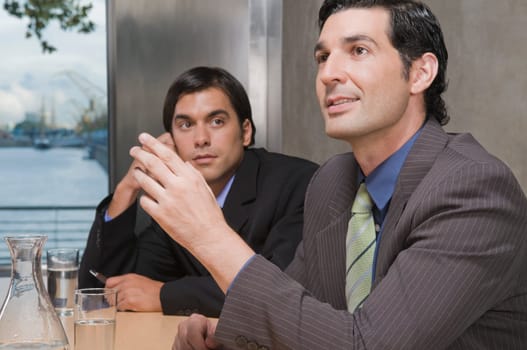 Two businessmen discussing in a conference room