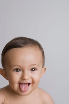 Close-up of a baby boy sticking his tongue out