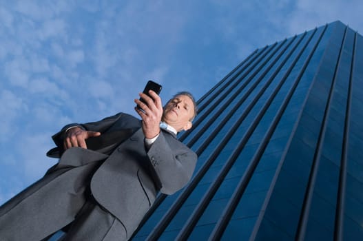 Low angle view of a businessman using a mobile phone