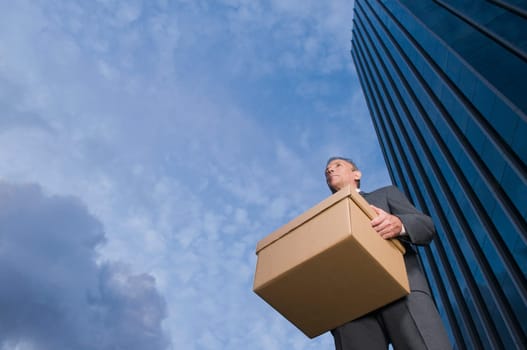 Low angle view of a businessman carrying a box