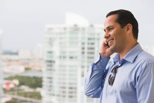 Man talking on a mobile phone and smiling