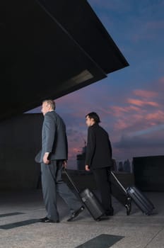 Businessmen carrying luggage