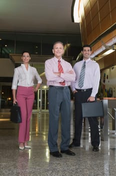 Portrait of business executives standing at an airport