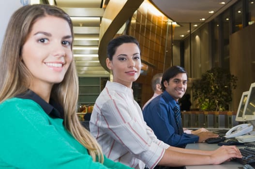 Customer service representatives working in an office