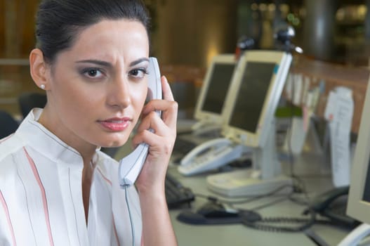 Female customer service representative talking on the telephone