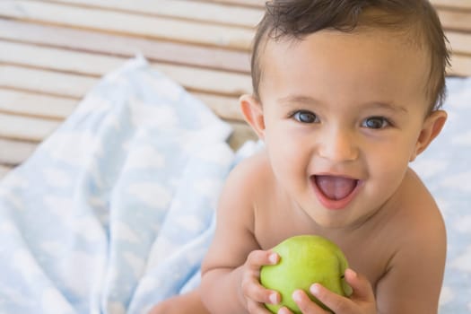 Baby boy holding an apple