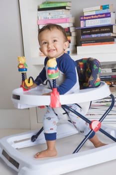 Baby boy playing in a walker