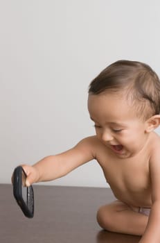 Baby boy playing with a mobile phone