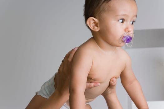 Baby boy sucking a pacifier