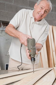 Man drilling on a wooden board