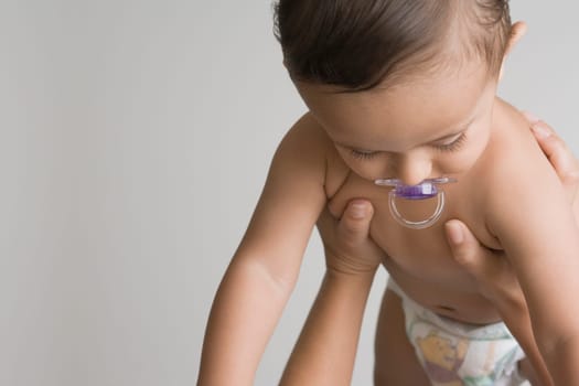 Baby boy sucking a pacifier