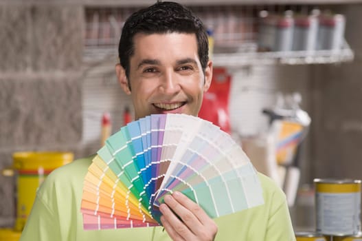 Man holding a color swatch in a hardware store