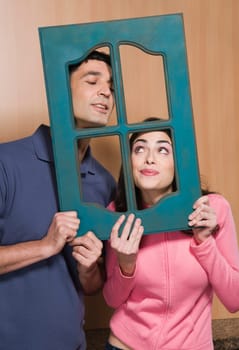 Close-up of a couple holding a window frame