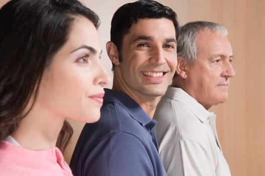 Man smiling with his family beside him