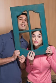 Portrait of a couple holding a window frame