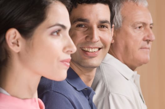 Man smiling with his family beside him