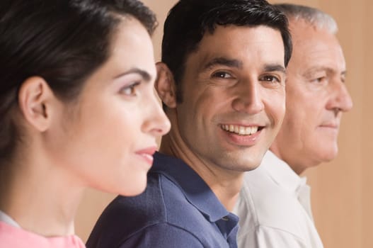 Man smiling with his family beside him