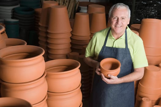 Man showing flower pot in a garden center