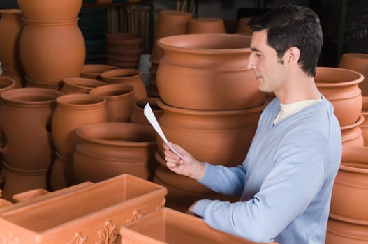 Man reading a shopping list in a garden center