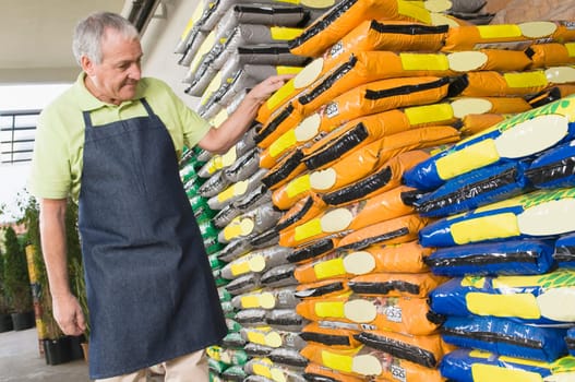 Man checking fertilizer in a garden center