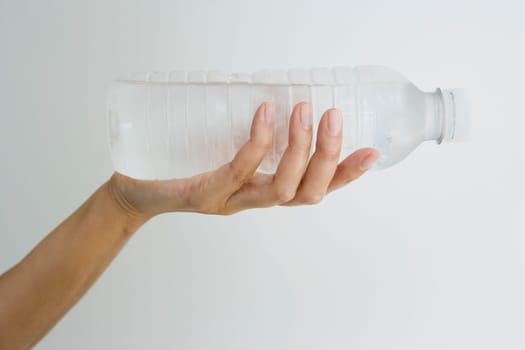 Close-up of a person's hand holding a water bottle