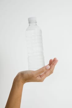 Close-up of a person's hand holding a water bottle