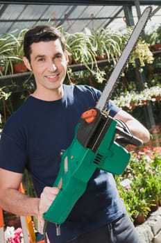 Man holding a chainsaw in a hardware store