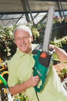 Man holding a chainsaw in a hardware store