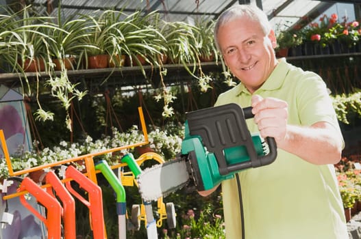 Man holding a chainsaw in a hardware store