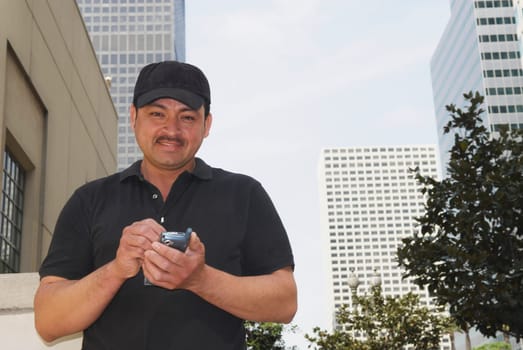Portrait of a male messenger using a mobile phone