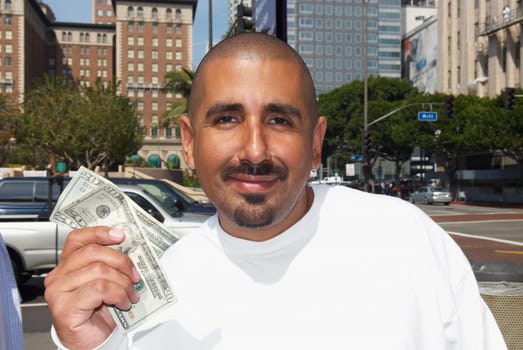 Portrait of a mid adult man holding US paper currency