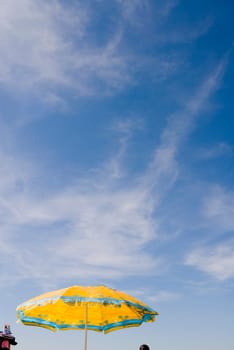 Yellow umbrella against blue sky