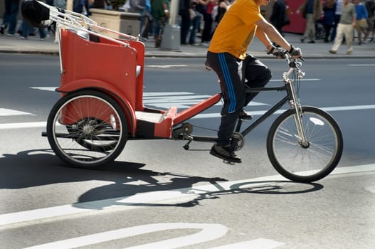 Low section view of a man riding a rickshaw