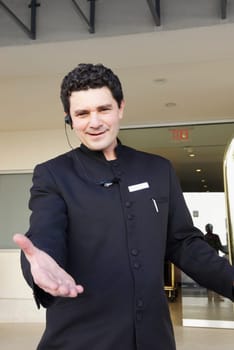 Portrait of a doorman gesturing