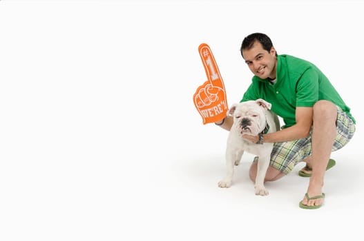Portrait of a young man with a Bulldog and smiling